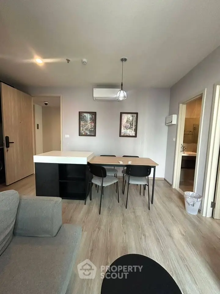 Modern living room with dining area and stylish decor in a contemporary apartment.