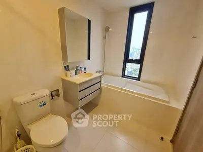 Modern bathroom with bathtub and city view window in high-rise apartment