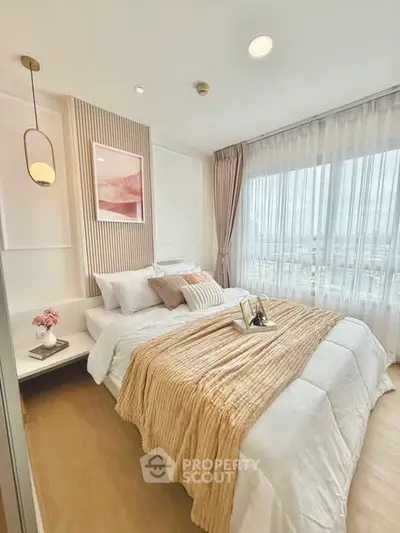 Luxurious bedroom with elegant decor and large windows offering natural light.