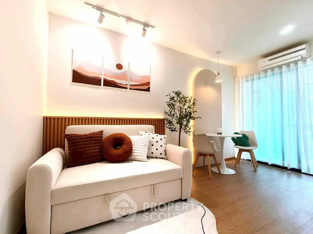 Modern living room with cozy sofa and elegant dining area, featuring stylish decor and natural light.