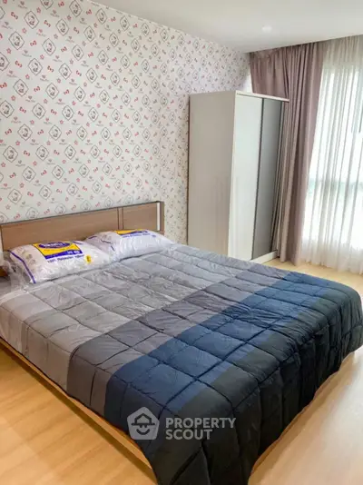 Cozy bedroom with stylish wallpaper and ample natural light