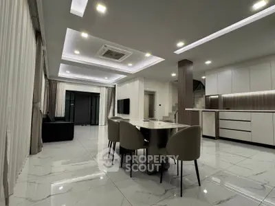 Luxurious modern living room with open kitchen and elegant dining area