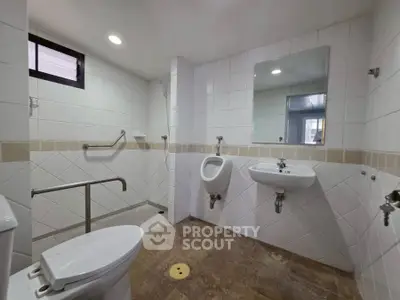 Spacious modern bathroom with accessible features and sleek design.