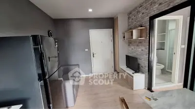 Modern apartment interior with sleek kitchen and cozy living area, featuring stylish decor and open layout.