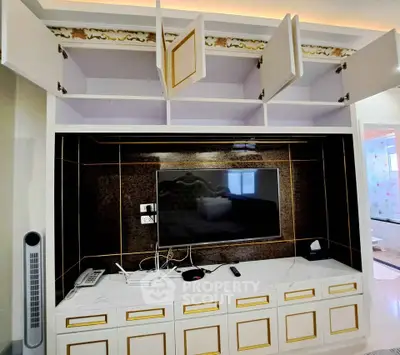 Luxurious living room with elegant built-in TV cabinet and ample storage space.