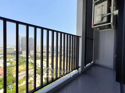 Spacious balcony with stunning city view and modern railing design.