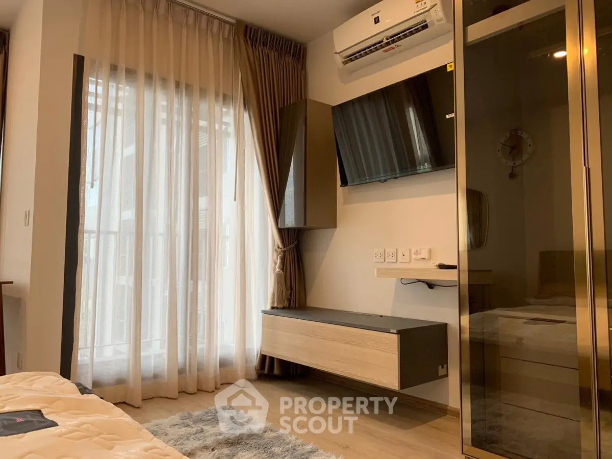 Modern bedroom with floor-to-ceiling windows and sleek furnishings