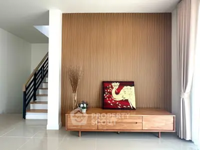 Stylish living room with modern wooden decor and elegant staircase