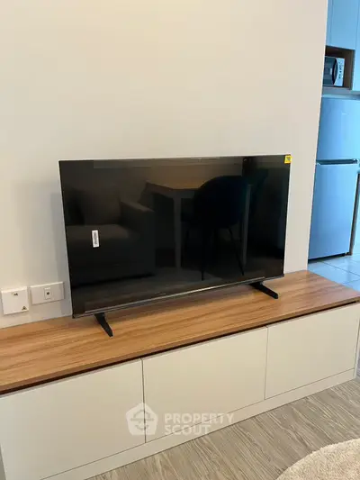 Modern living room with sleek TV setup and stylish furniture