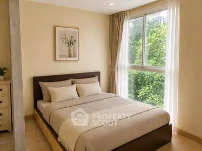Cozy bedroom with large window and elegant decor, offering a serene view of lush greenery.