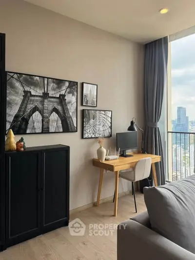 Modern living room with city view, stylish decor, and workspace setup.