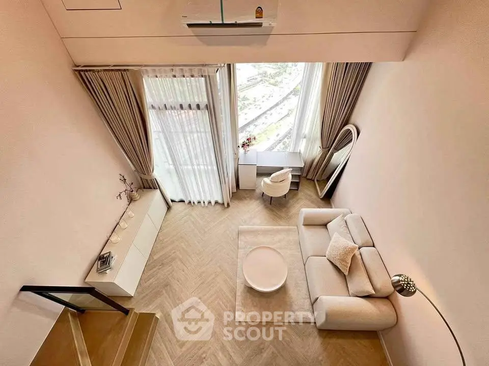 Elegant modern living room with high ceiling and large window offering stunning views.