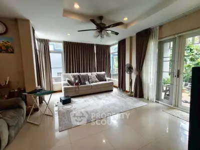 Spacious living room with large windows and elegant decor