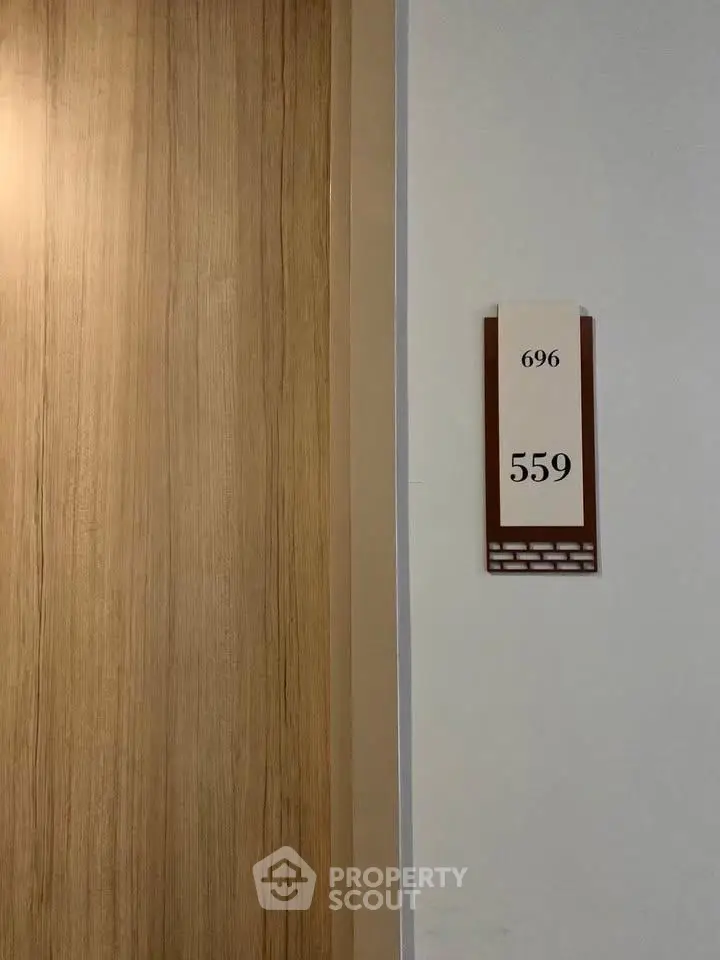 Modern apartment door with room number 559 in a stylish hallway.