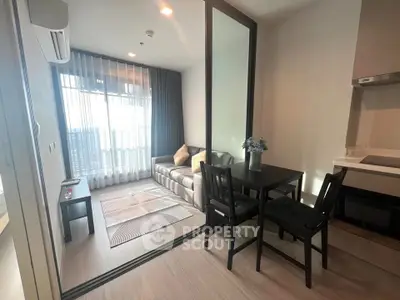 Modern living room with glass partition and cozy dining area