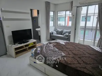 Modern studio apartment with cozy bed and natural light