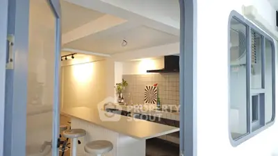 Modern kitchen with sleek design and open layout, featuring a stylish breakfast bar and contemporary lighting.