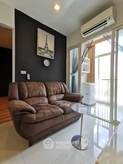 Modern living room with cozy brown sofa and balcony view