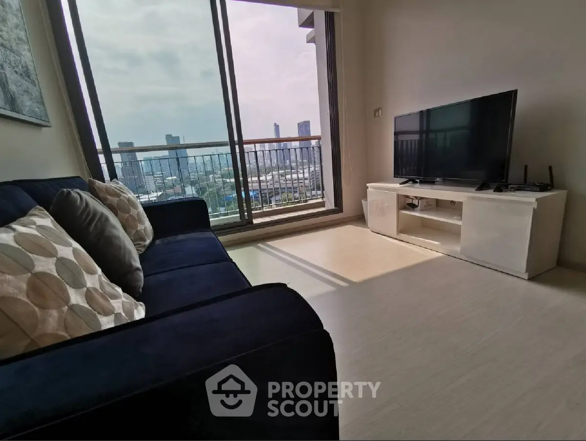 Modern living room with city view, featuring a sleek sofa and large TV, perfect for urban living.