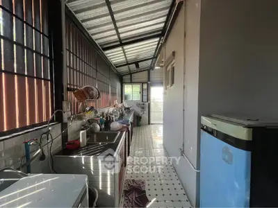 Charming narrow kitchen with natural light and modern appliances