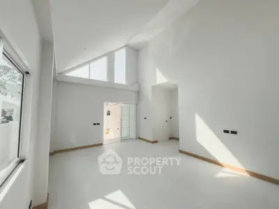 Spacious modern living room with high ceilings and large windows