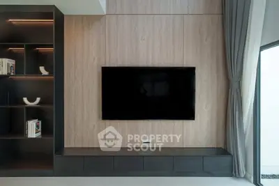 Modern living room with sleek TV setup and elegant shelving