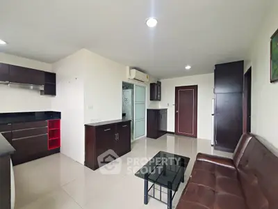 Modern open-layout living room with sleek kitchen and stylish furniture