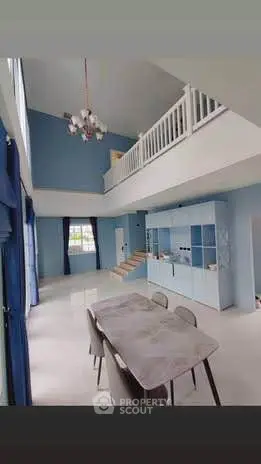 Spacious modern living room with high ceilings and elegant dining area in a stylish duplex.
