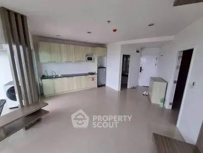 Spacious modern kitchen with sleek cabinetry and open layout in a bright apartment.