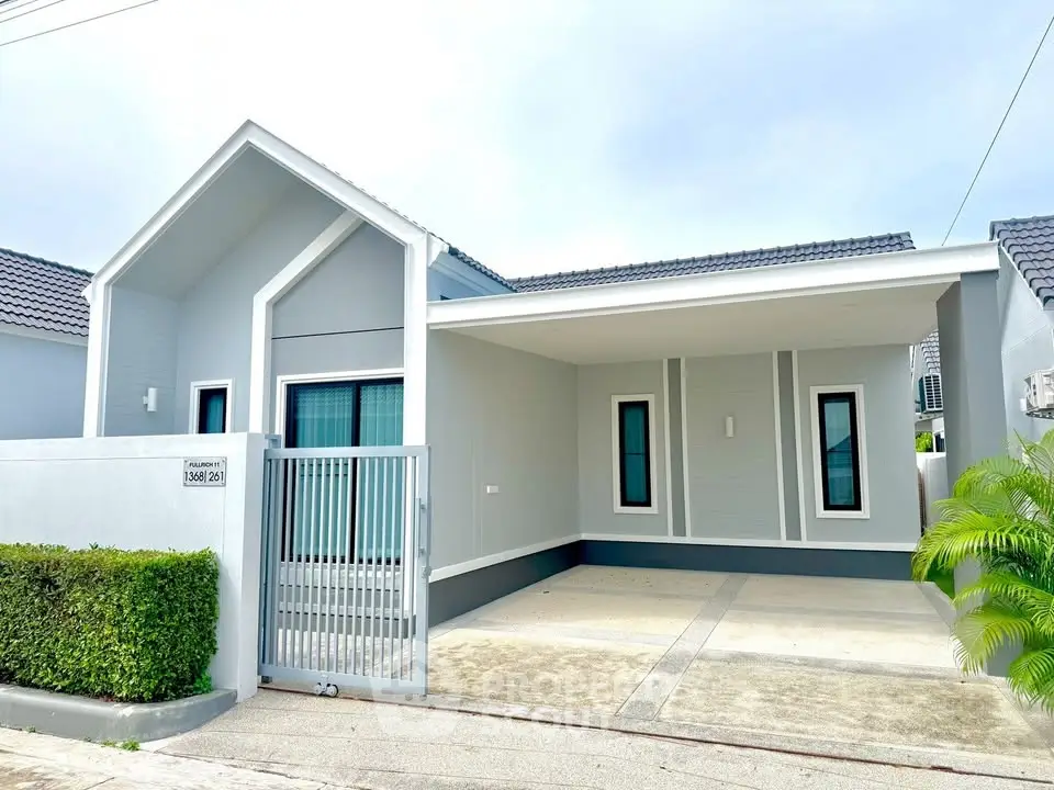 Modern single-story house with sleek design and spacious driveway