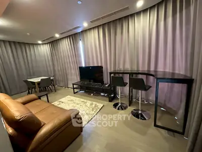 Modern living room with sleek furniture and ambient lighting, perfect for relaxation and entertainment.