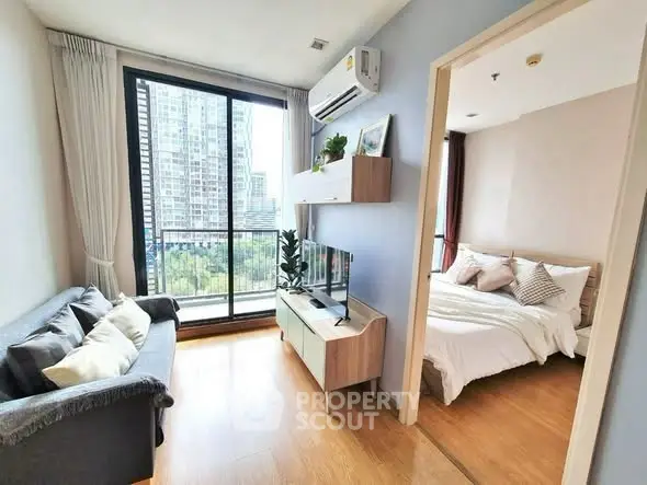 Modern apartment living room with large window and bedroom view