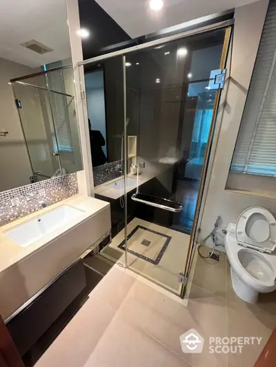 Modern bathroom with glass shower and sleek fixtures