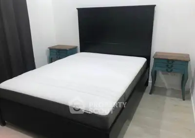 Cozy bedroom with elegant black bed frame and stylish side tables