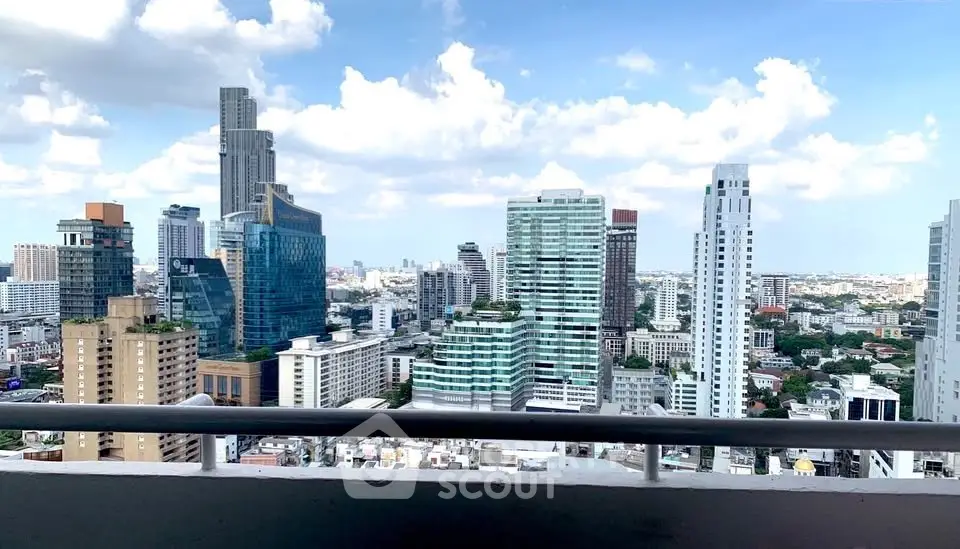 Stunning cityscape view from a high-rise balcony showcasing modern skyscrapers and blue sky.