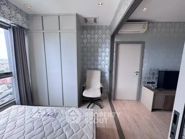 Modern bedroom with city view, featuring mirrored wardrobe and sleek design.
