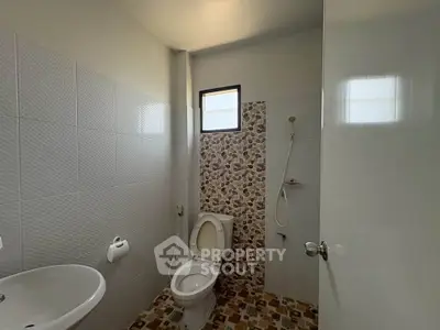 Compact bathroom with modern fixtures and natural light