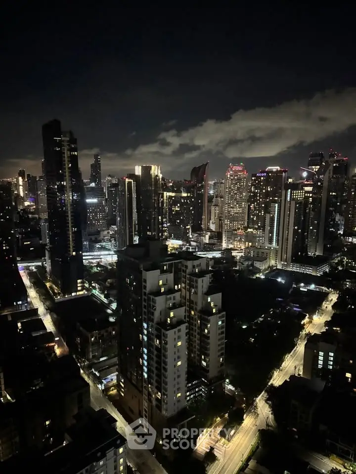 Stunning nighttime cityscape view showcasing illuminated skyscrapers and bustling streets, perfect for urban living enthusiasts.