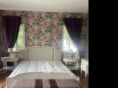 Charming bedroom with floral wallpaper and elegant furniture