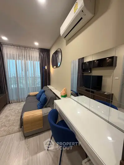 Modern living room with stylish decor, featuring a cozy sofa, sleek TV unit, and elegant mirrored desk.