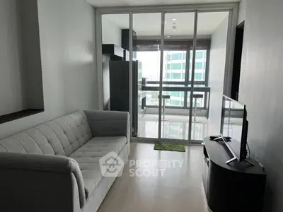 Modern living room with balcony view in high-rise apartment