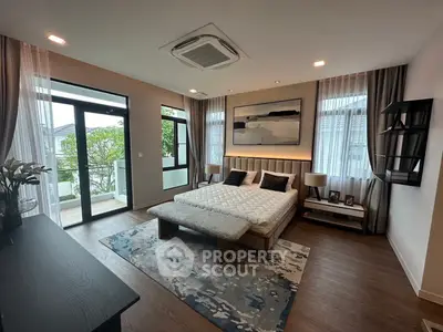 Luxurious modern bedroom with balcony access and elegant decor