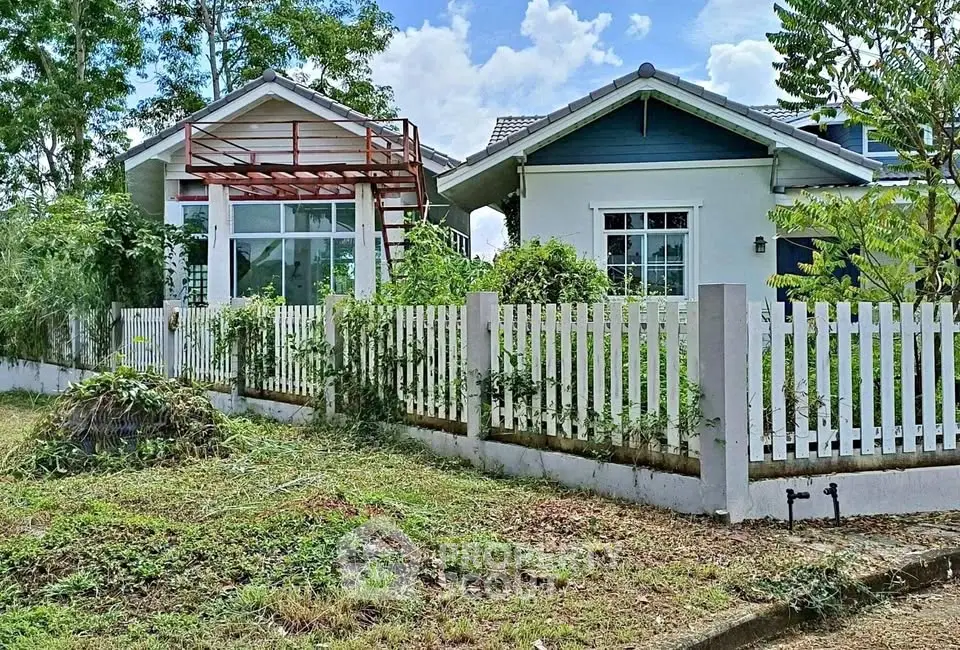 Charming suburban house with white picket fence and lush greenery