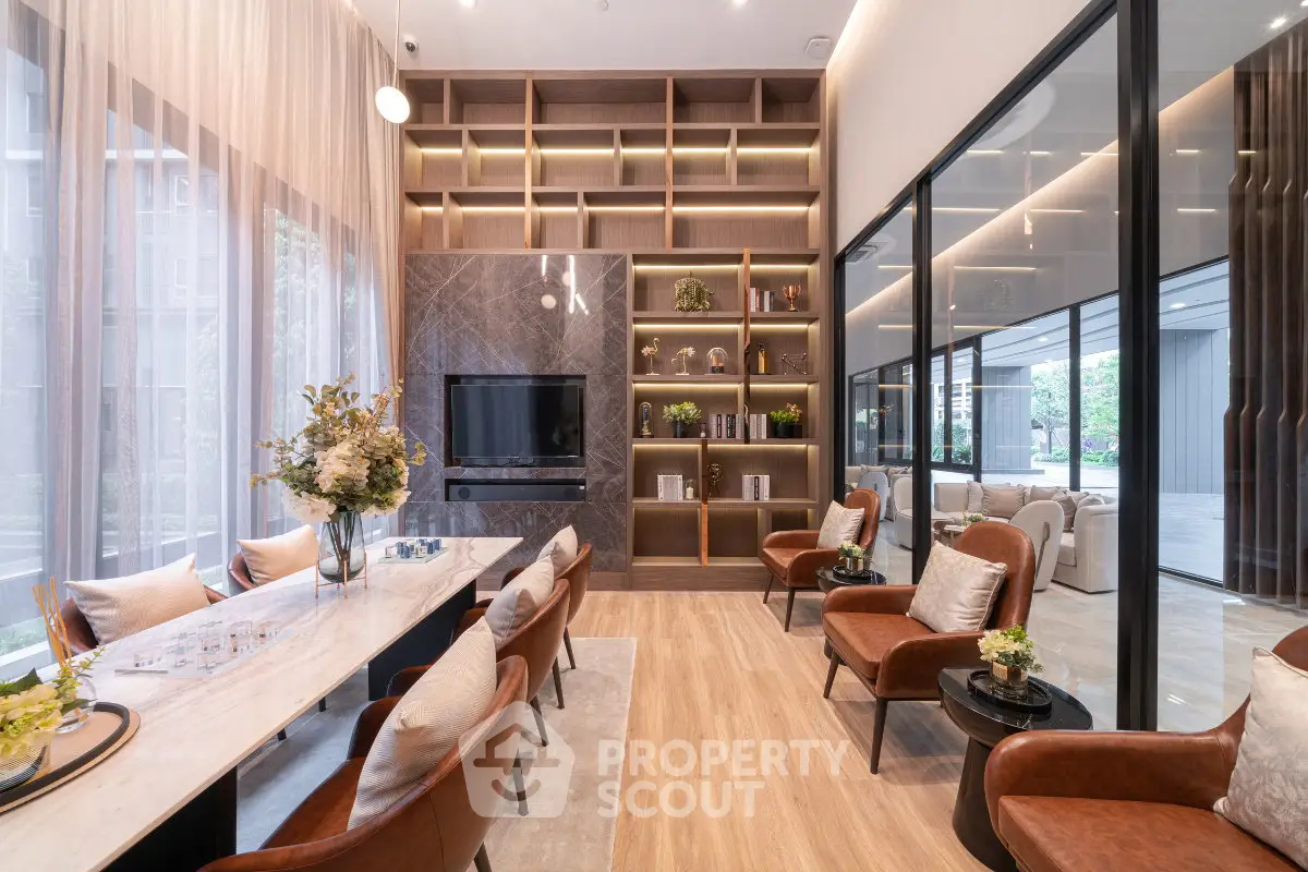 Luxurious modern living room with elegant decor and large windows offering natural light.