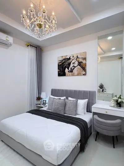 Luxurious bedroom with elegant chandelier and modern decor