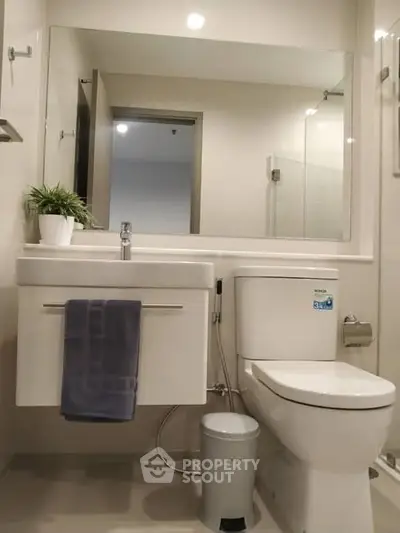 Modern bathroom with sleek fixtures and large mirror