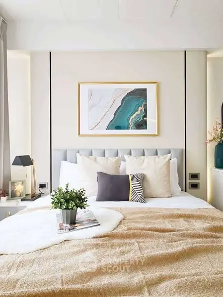Elegant bedroom with modern decor and stylish artwork above the bed.