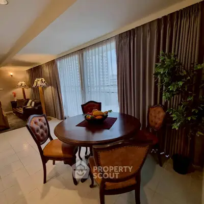 Elegant living room with classic furniture and large windows offering city views.