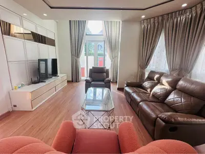 Spacious living room with elegant furniture and large windows for natural light.