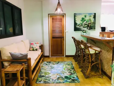Charming tropical-themed living room with bamboo furniture and vibrant decor